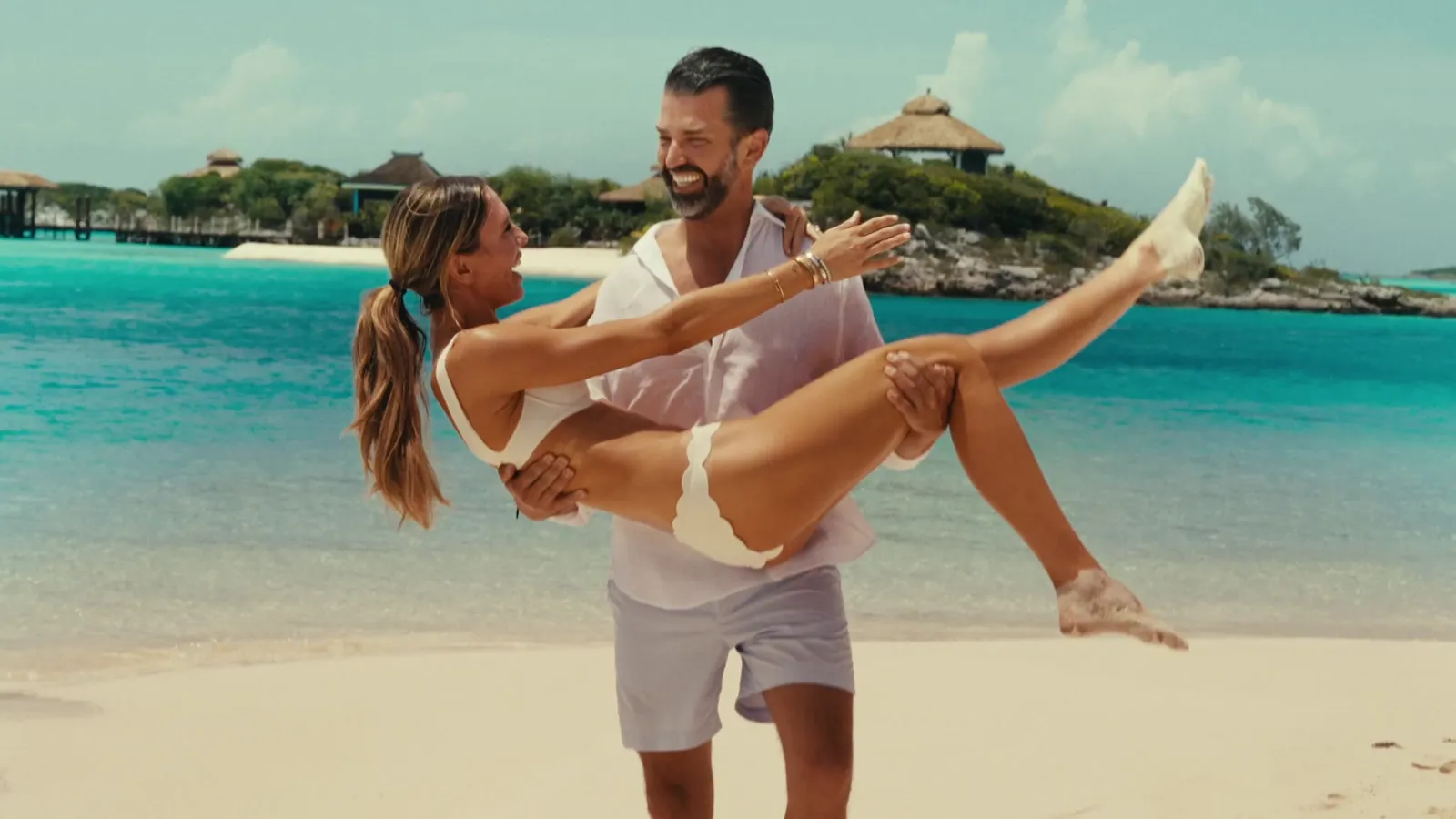 Donald carrying Bettina along the beach