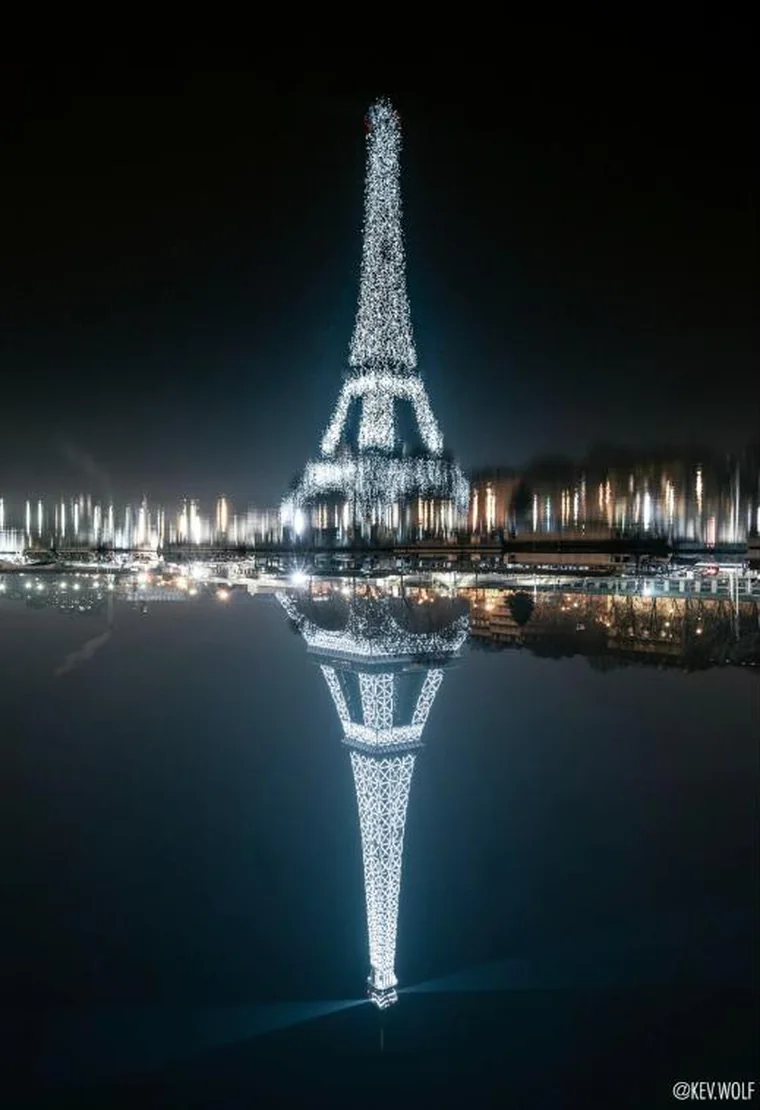 The Eiffel Tower flipped, the reflection reading as an oil painting