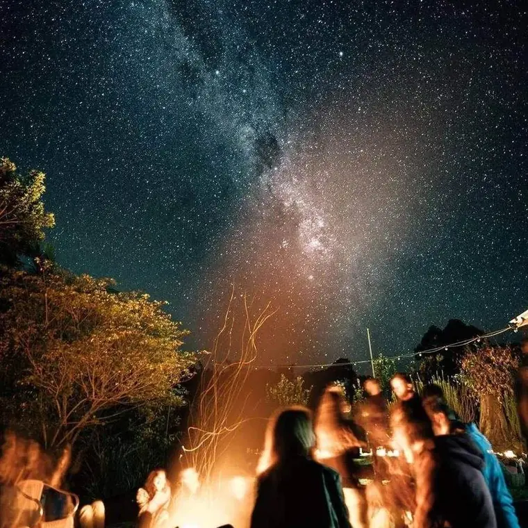 The Milky Way over a fire on the beach